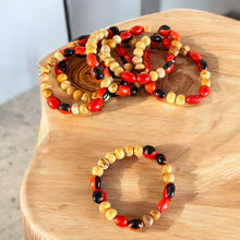 Load image into Gallery viewer, Handcrafted Bracelet with Palo Santo and Huayruro Seeds | Made from Ethically Sourced Palo Santo and Authentic Huayruro Seeds | Symbolizes Good Luck, Protection, and Positive Energy