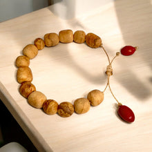 Load image into Gallery viewer, Handcrafted Bracelet with Palo Santo and Huayruro Seeds | Made from Ethically Sourced Palo Santo and Authentic Huayruro Seeds | Symbolizes Good Luck, Protection, and Positive Energy