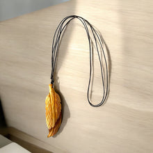 Load image into Gallery viewer, Handcrafted Feather Necklace Made of Palo Santo | Elegantly Carved from Ethically Sourced Palo Santo Wood | A Unique Piece that Symbolizes Freedom, Spirituality, and Connection to Nature
