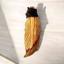 Load image into Gallery viewer, Handcrafted Feather Necklace Made of Palo Santo | Elegantly Carved from Ethically Sourced Palo Santo Wood | A Unique Piece that Symbolizes Freedom, Spirituality, and Connection to Nature
